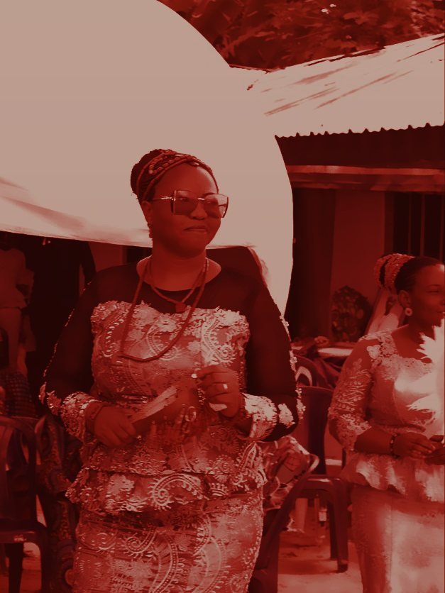 Edo woman in traditional lace attire and coral beads at a ceremony